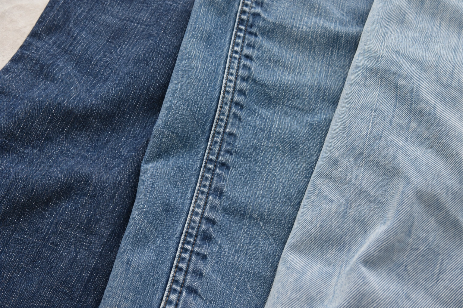Denim wash concept: indigo twill, seam fading and soft washed blue