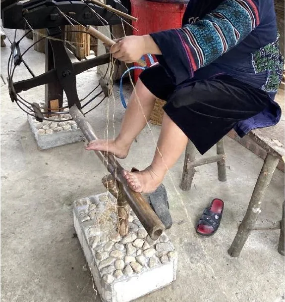 Hands, feet and a traditional fibre-processing apparatus